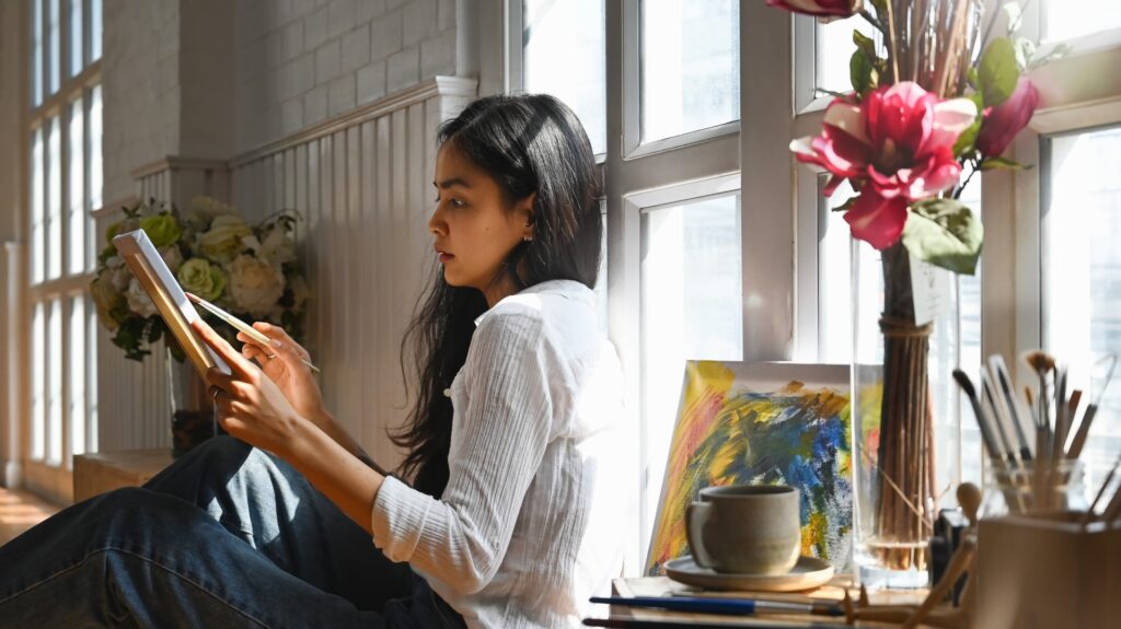 Woman painting on a canvas